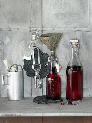 An Arrangement Of Cherry-vanilla Syrup In Bottles And Kitchen Utensils Print