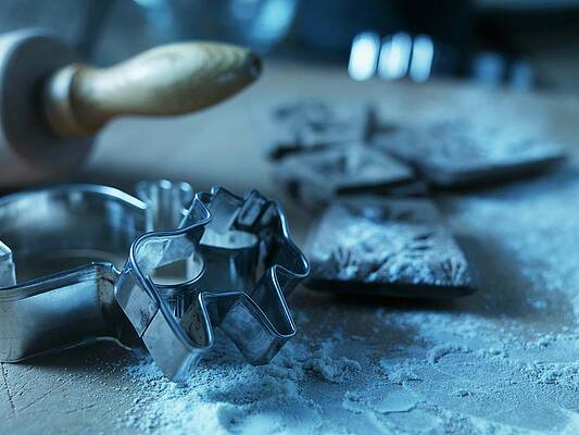 An Arrangement Of Cookie Cutters, A Rolling Pin And Flour Print