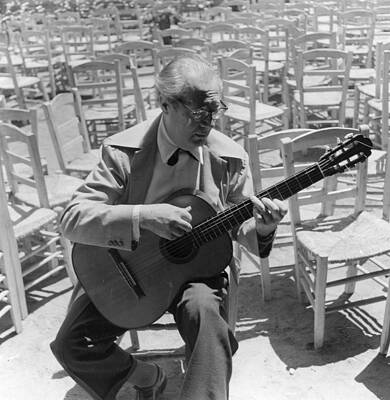 Guitarist Amidst Empty Chairs Wall Art