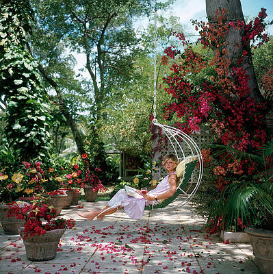 Woman Relaxing in Garden Swing Wall Art