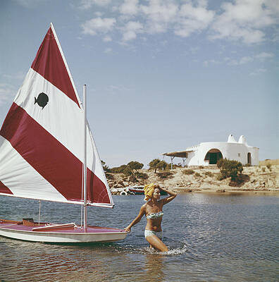 Woman Beside a Red and White Sailboat Wall Art