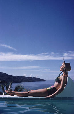 Woman Relaxing by Infinity Pool Wall Art