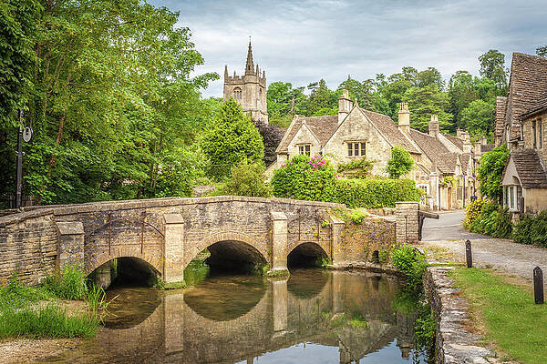 British Wall Art featuring the digital art Bridge Across Bybrook River In Castle Combe, Wiltshire, England, Great Britain by Christian Muringer