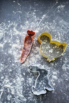 Bunny, Carrot And Chick Shaped Cookie Cutters On A Surface Dusted With Flour Print