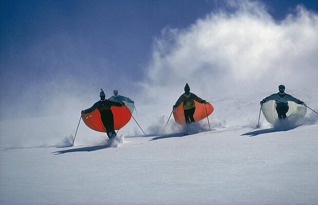 Colorful Skiers Descend a Snowy Slope Wall Art