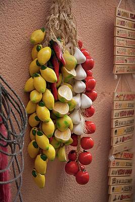 Ceramic Lemons, Garlic And Tomatoes Hanging From A Shop Wall In Cefalu, Sicily Print