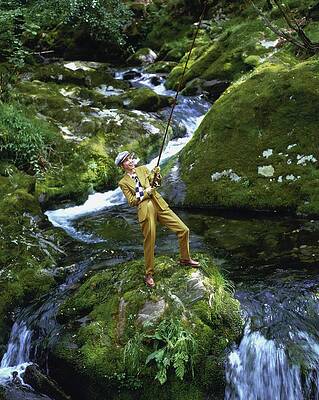 Wall Art featuring the photograph Christy Turlington Fishing On A Mossy Rock by Arthur Elgort