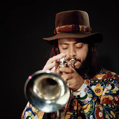 Man Playing Trumpet in Colorful Attire Photograph
