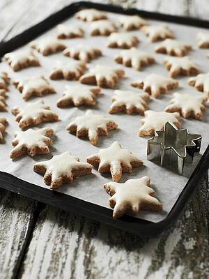Cinnamon Stars On A Baking Tray With A Cutter Print