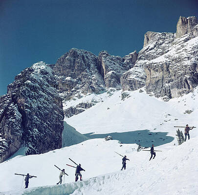 Skiers Ascending Snowy Mountain Slope Wall Art