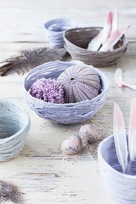 Decorative Arrangement Of Feathers, Sea Urchin Tests And Pompoms In Hand-made Yarn Bowls Print