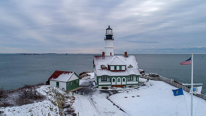 Maine Photograph - First Snow At Portland Head Lighthouse by Veterans Aerial Media LLC