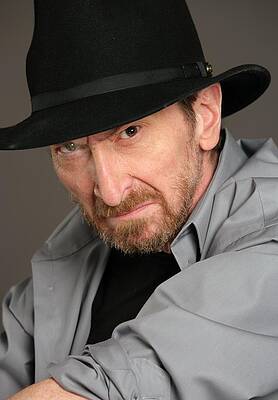 Man in Black Hat and Gray Coat Wall Art