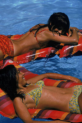 Two Women Relaxing on Pool Floats Wall Art