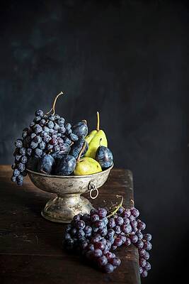 Grapes, Plums And Pears In A Metal Bowl On A Wooden Table Print