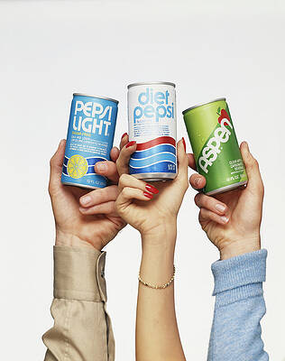 Wall Art featuring the photograph Human Hand Holding Cold Drink Tins by Tom Kelley Archive