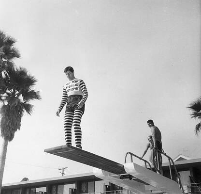 Man in Striped Outfit on Diving Board Wall Art
