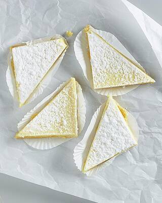 Lemon Tart Triangles With Icing Sugar On White Parchment Paper Print