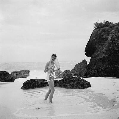 Woman on Rocky Beach Wall Art