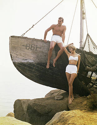 Couple Relaxing by a Wooden Boat Wall Art