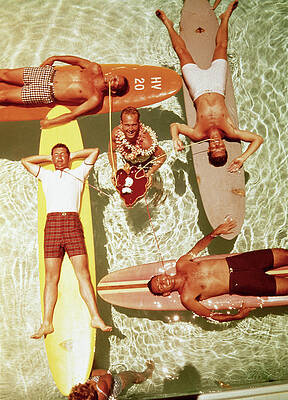 Wall Art featuring the photograph Men On Surfboards In Pool Sipping Drinks by Tom Kelley Archive