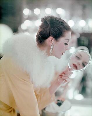 Wall Art featuring the photograph Model Gazing Into A Hand Mirror by Karen Radkai