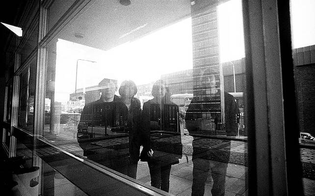 Reflection of Four People in Window Wall Art
