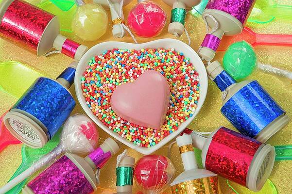 Overview Still Life Close Up Of Heart Dish With A Pink Chocolate Heart Shape And Coloured Party Poppers And Plastic Ice Cream Spoons Print