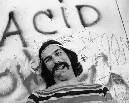 Smiling Man in Front of Graffiti Wall Art