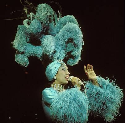 Performer in Extravagant Blue Costume Photograph