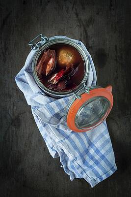 Pickled Eggs With Onions Skins And A Spiced Liquid In A Preserving Jar On A Checked Cloth On A Wooden Table Print