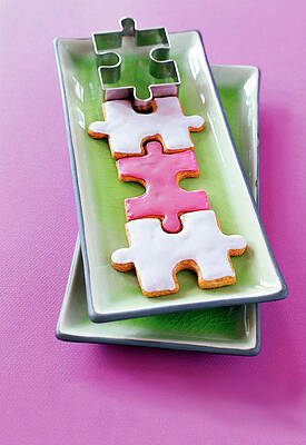 Puzzle Shaped Cookies And Cutter On Green Ceramic Plate Print