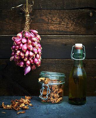 Food And Drink Photograph - Shallots Hanging Up, Chanterelles In A Jar, And A Bottle Of Olive Oil by Ria Osborne