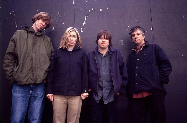 Group Standing Against Dark Wall Wall Art