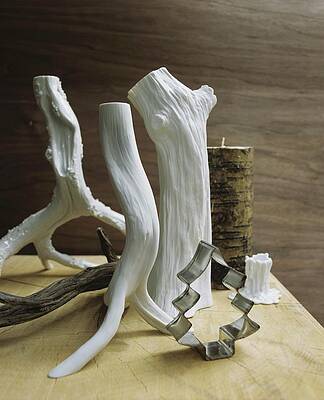 Stylised White Branches And Festive Cookie Cutters On Table Print