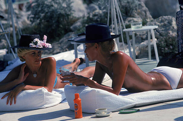 Two Women Relaxing by the Pool Wall Art