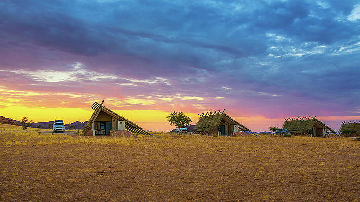 Sunrise Wall Art featuring the photograph Sunrise Above Small Chalets Of A Desert Lodge Near Sossusvlei In Namibia by Miroslav Liska