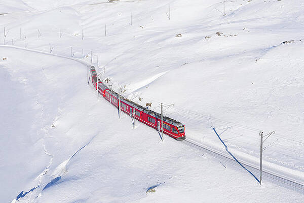 Freeze Wall Art featuring the digital art Switzerland, Graubunden, Grisons, Engadin, Alps, The Bernina Express Train At The Bernina Pass by Alessandro Bellani