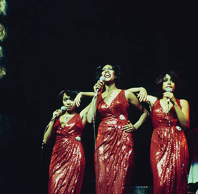 Three Women Performing in Red Dresses Photograph