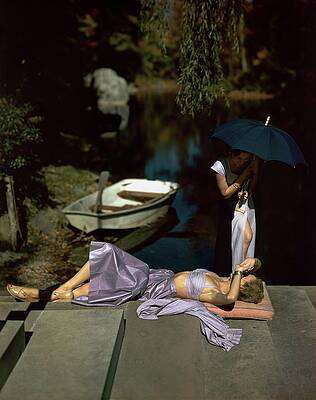 Wall Art featuring the photograph Two Models At The Edge Of A Pond by John Rawlings