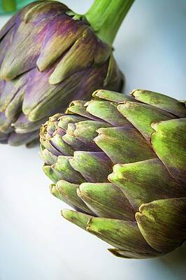 Two Purple Artichokes On A Light Surface Print