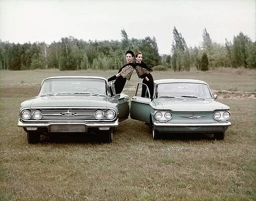 Wall Art featuring the photograph Two Women Leaning Out Of Cars by John Rawlings