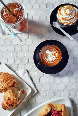 Various Coffee Drinks And Sweet Pastries On A Table In A Coffee Bar Print