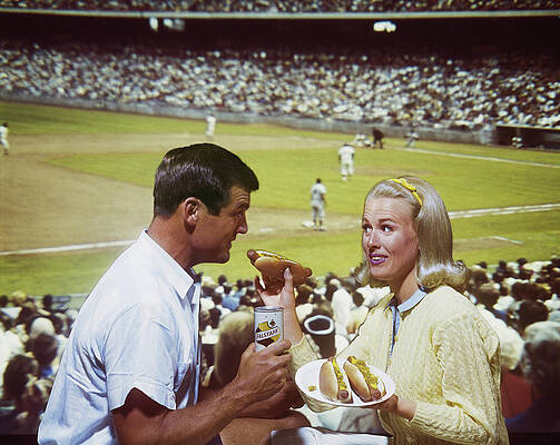 Wall Art featuring the photograph Woman Feeding Man Hot Dog, Smiling by Tom Kelley Archive