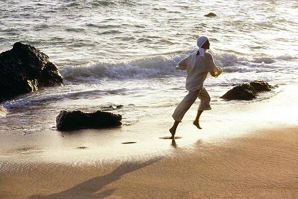 Wall Art featuring the photograph Woman Running On The Beach by Stan Malinowski