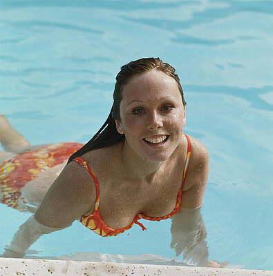 Wall Art featuring the photograph Young Woman Swimming In Pool, Smiling by Tom Kelley Archive