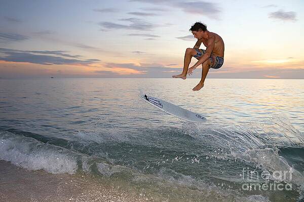 Surfer Performing a Trick at Sunset Wall Art