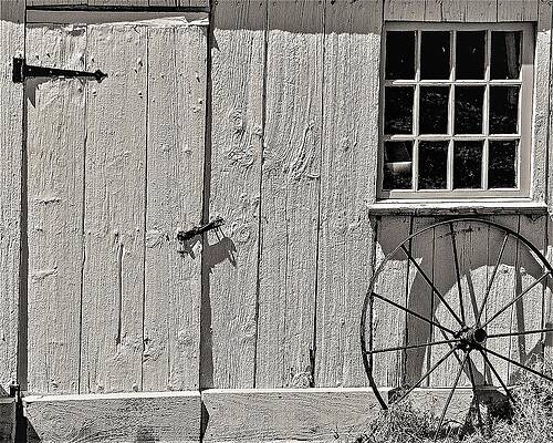 Wall Art featuring the photograph Barn Door Wheel #1 by John Linnemeyer