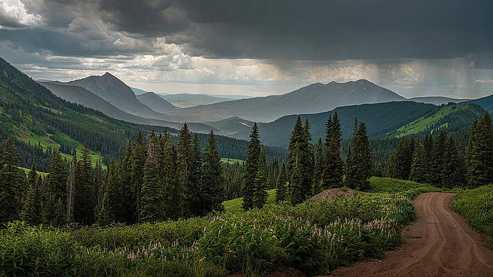 Mountain Road Under Stormy Sky Photograph