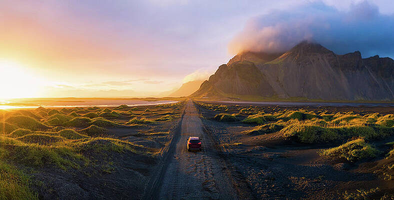 Wall Art featuring the photograph Gravel Road At Sunset With Vestrahorn Mountain And A Car Driving, Iceland #1 by Miroslav Liska